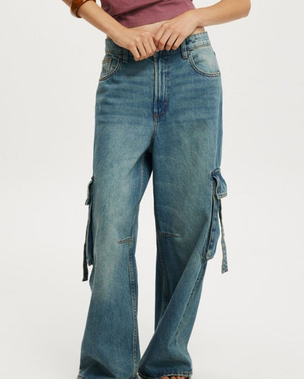 Blue jeans with decorative elements on a white background