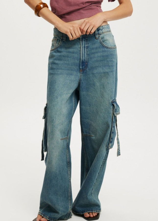 Blue jeans with decorative elements on a white background