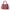 Pink handbag with gold accents on a white background