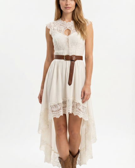 Woman wearing a white lace dress with a brown belt and boots on a white background