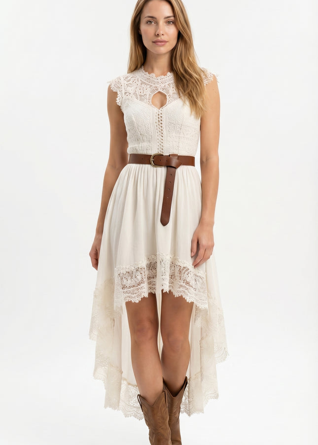 Woman wearing a white lace dress with a brown belt and boots on a white background