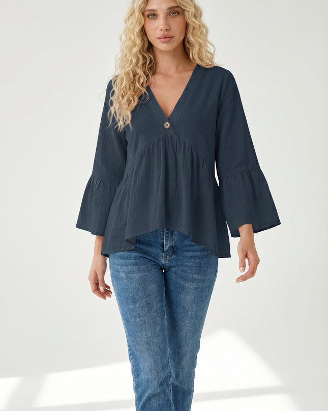 Woman wearing a navy blue blouse and jeans on a white background