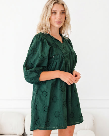 Woman wearing a green dress with a white background
