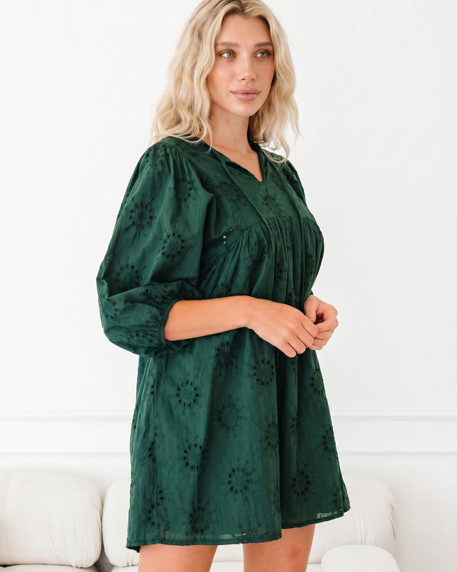 Woman wearing a green dress with a white background