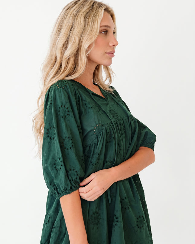 Woman wearing a green dress with a white background