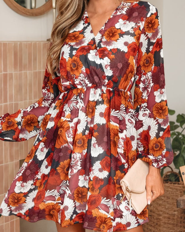 Woman wearing a floral dress with long sleeves in a home setting.