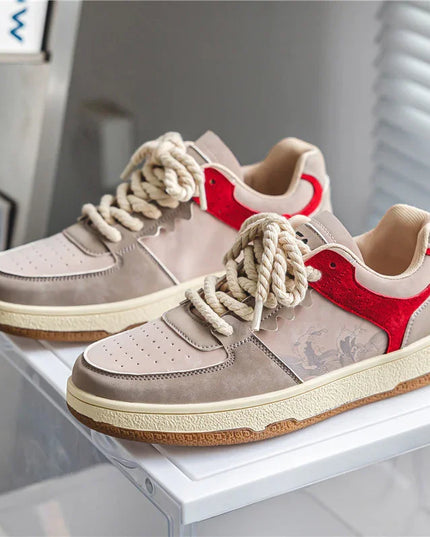 Pair of sneakers with red heart design on a white surface