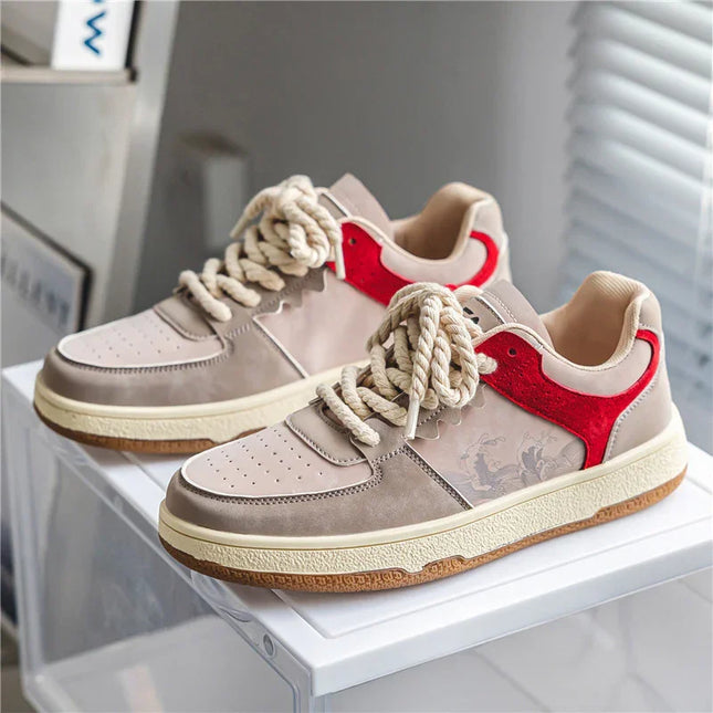 Pair of sneakers with red heart design on a white surface