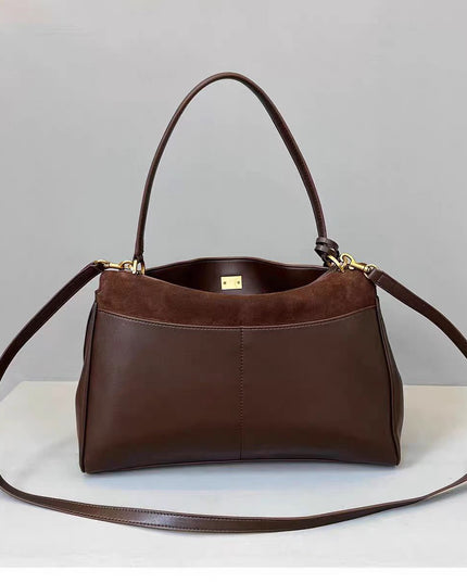 Brown leather handbag with a gold clasp on a light gray background