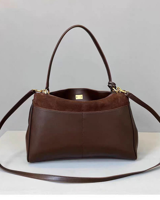 Brown leather handbag with a gold clasp on a light gray background