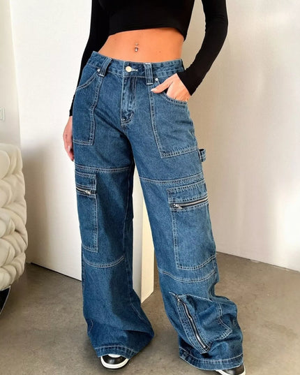 Person wearing blue wide-leg jeans and a black top indoors.