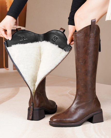 Brown knee-high boots with white fur lining held open to show interior.