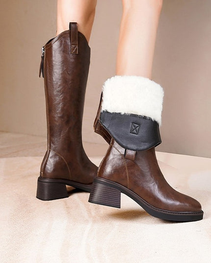 Brown leather boots with white fur lining on a neutral background