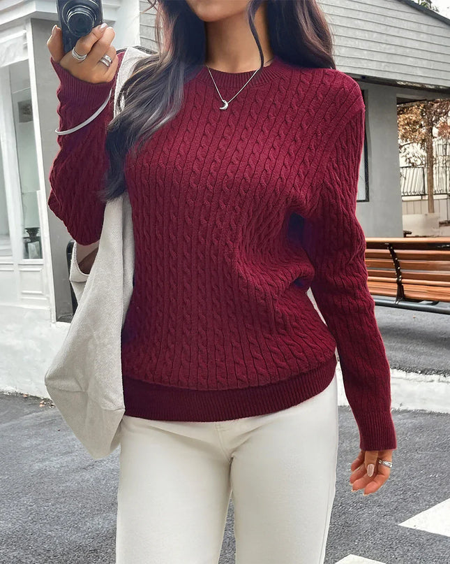 Person wearing a red sweater and white pants taking a selfie outdoors.