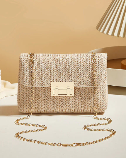 Beige woven handbag with a gold chain strap on a neutral background