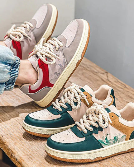 Two pairs of colorful sneakers on a wooden surface with a neutral background.