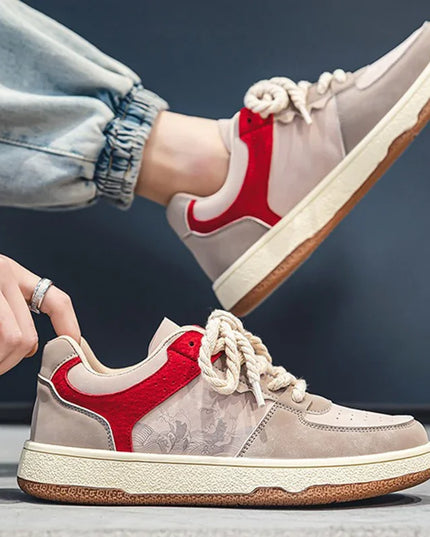 Beige and red sneakers with floral pattern on a dark background