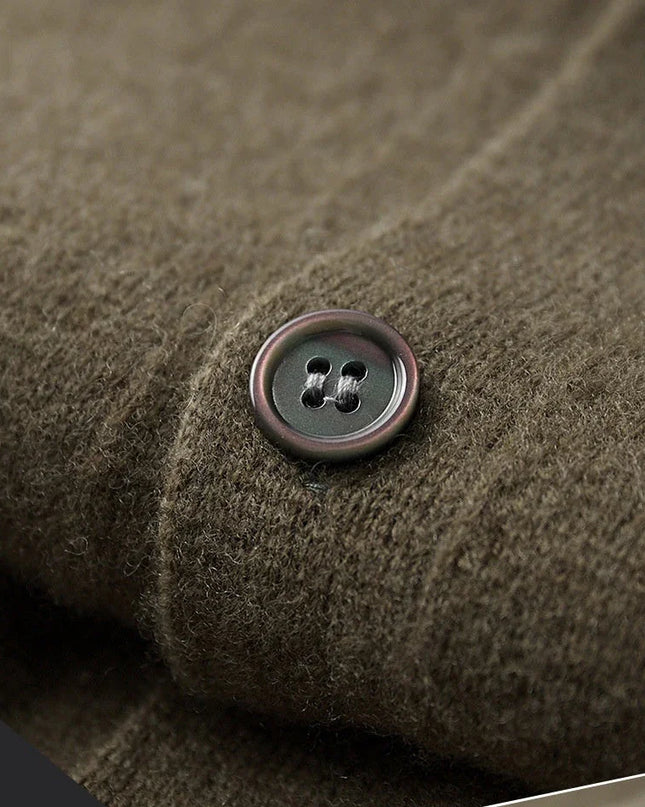 Close-up of a button on textured brown fabric with 'fabric exhibit' text.