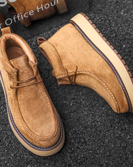 Brown suede shoes on a textured black surface