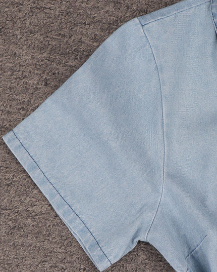 Light blue denim fabric on a brown textured surface