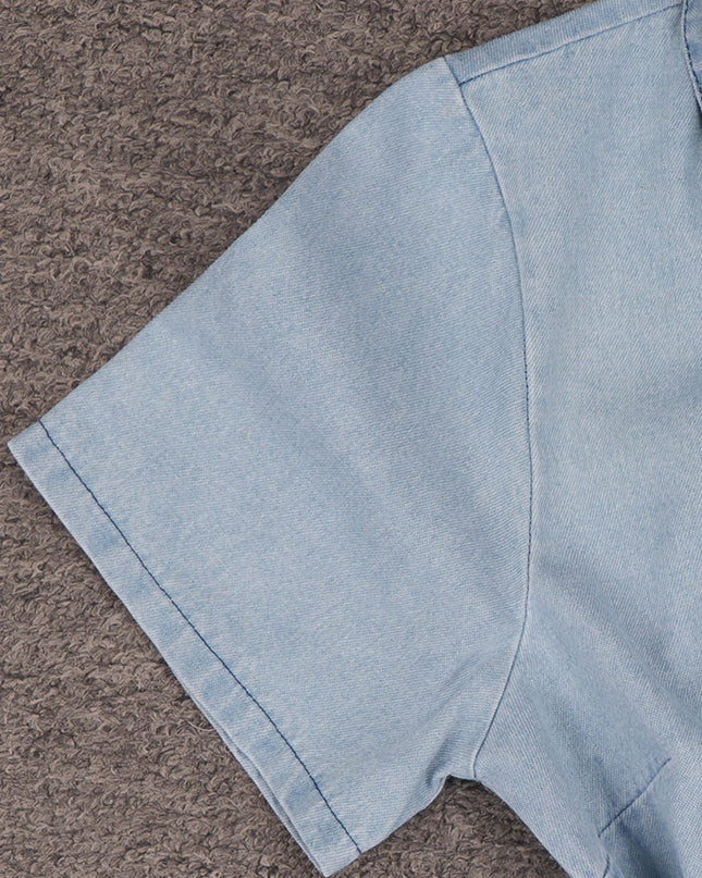 Light blue denim fabric on a brown textured surface