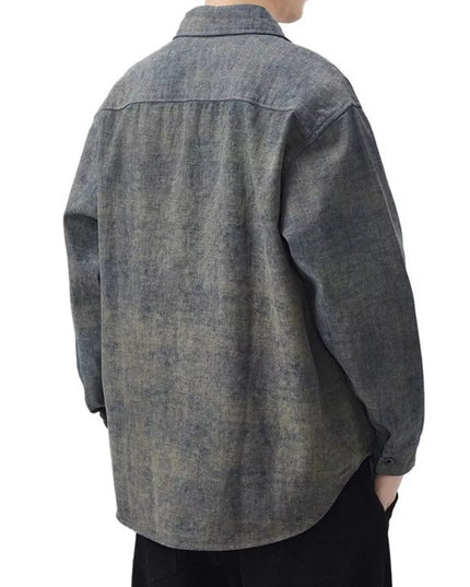 Person wearing a gray denim shirt on a white background