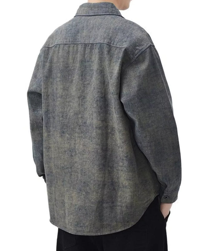 Person wearing a gray denim shirt on a white background