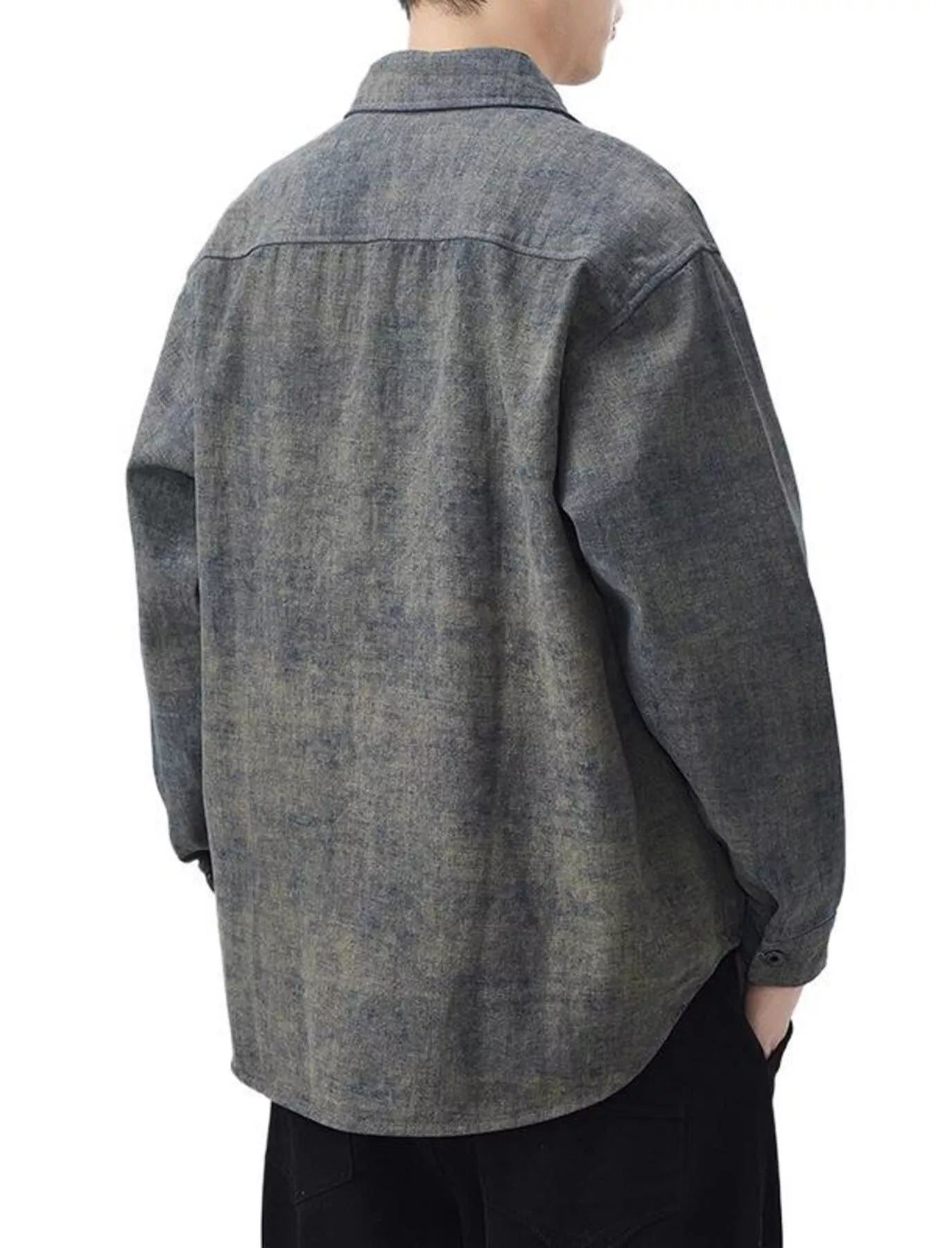 Person wearing a gray denim shirt on a white background
