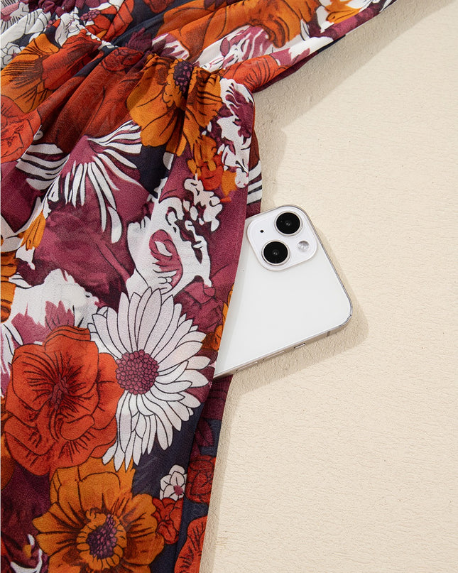 Floral-patterned fabric with a phone case on a beige surface