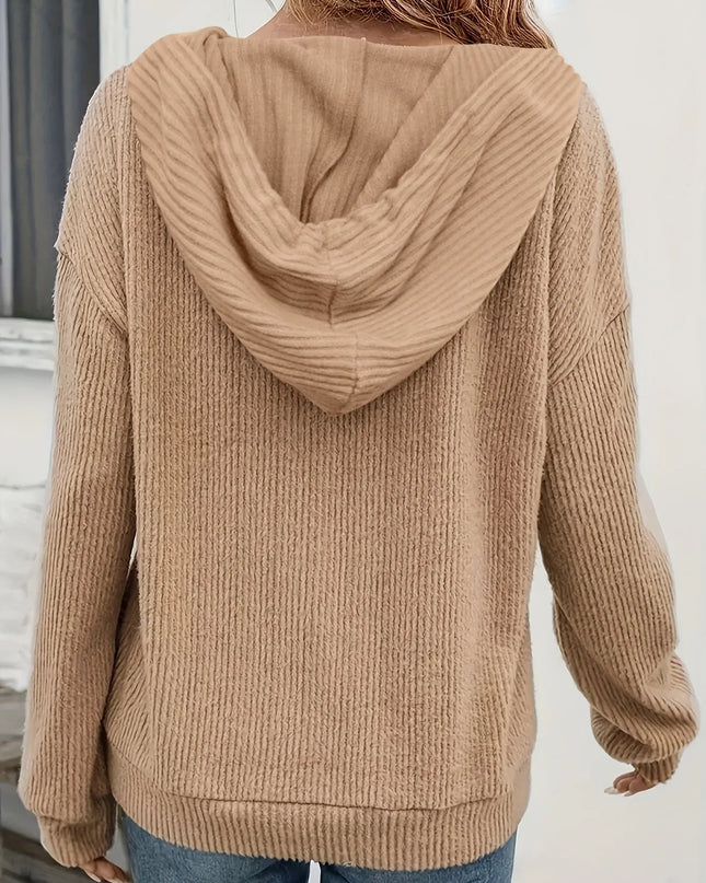 Person wearing a beige hoodie from behind with a neutral background