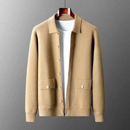 Beige cardigan on a hanger against a gray background