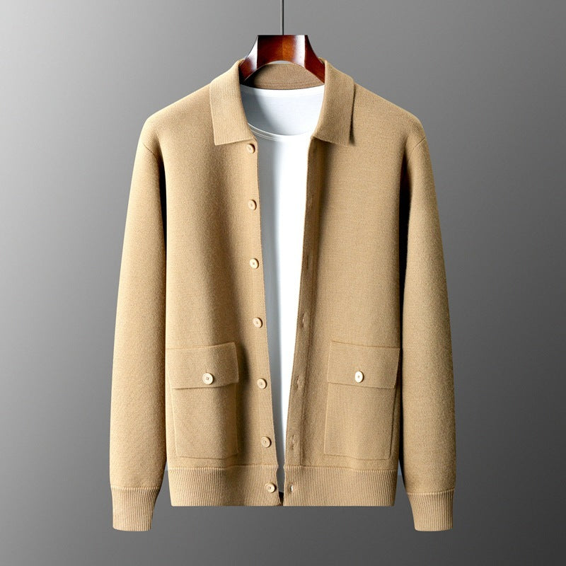 Beige cardigan on a hanger against a gray background