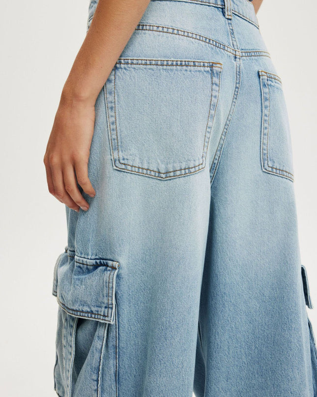 Light blue denim cargo pants on a white background
