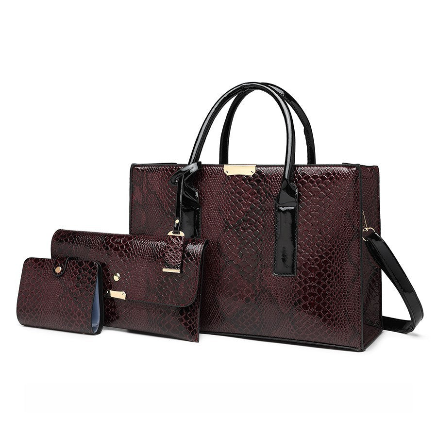 Set of three brown textured handbags with black handles and straps on a white background