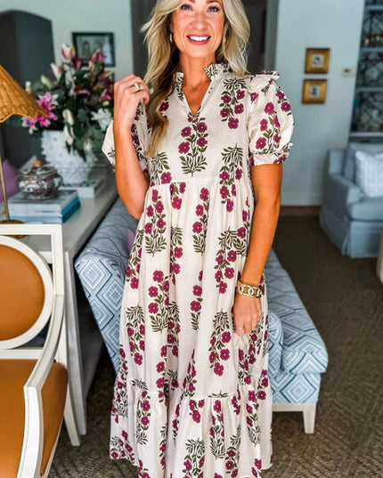 Woman wearing a floral dress in an indoor setting with decor elements.