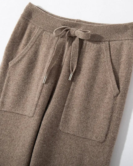 Brown knitted pants with drawstring on a light gray background