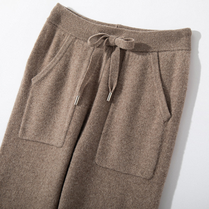 Brown knitted pants with drawstring on a light gray background