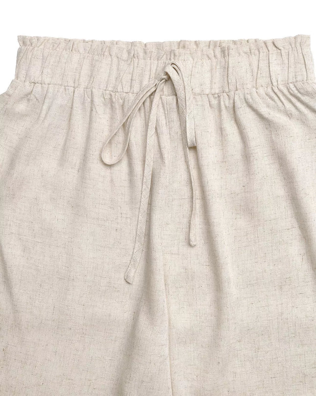 Beige pants with drawstring waist on a light beige background