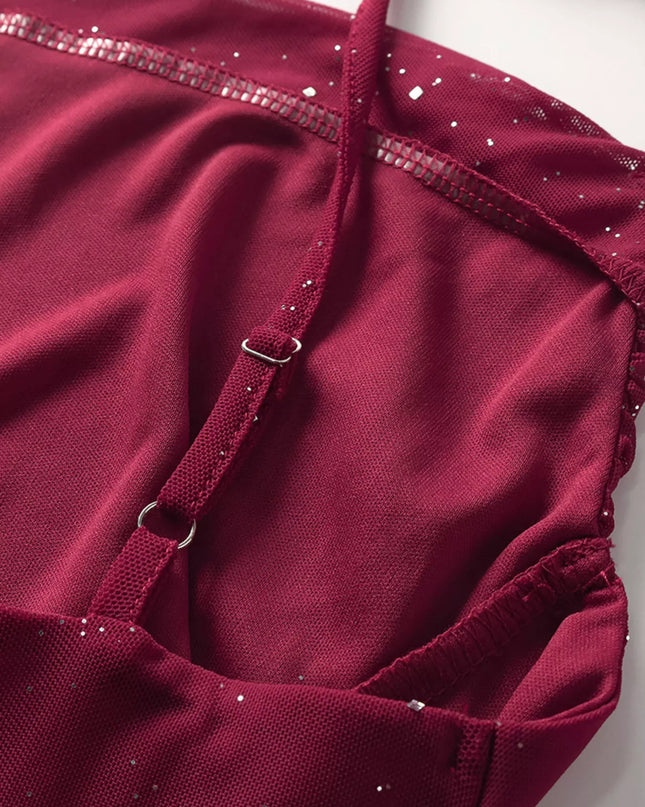 Close-up of a maroon leotard with glittery details on a white background