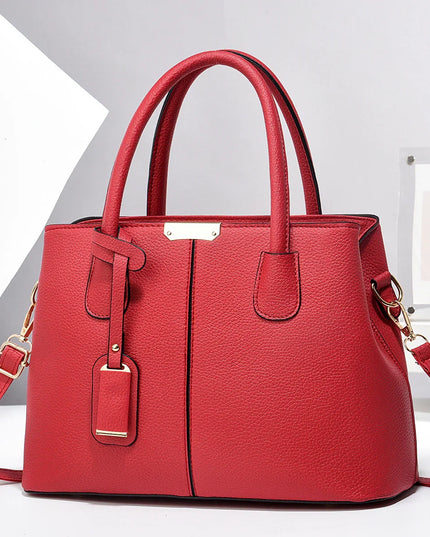 Red handbag with gold accents on a white background