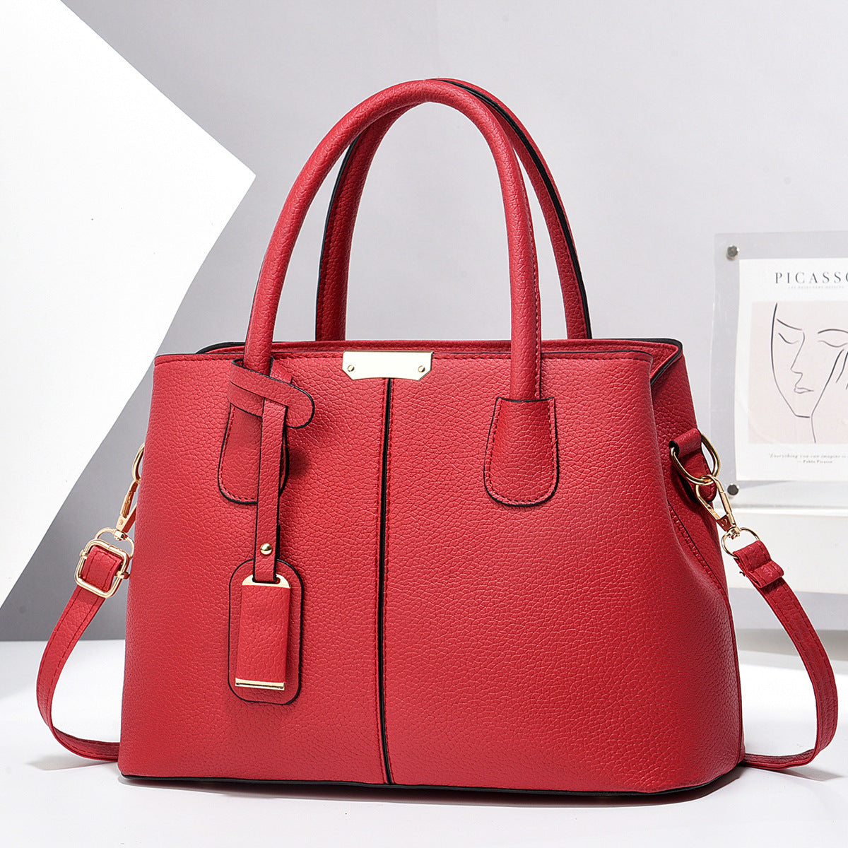 Red handbag with gold accents on a white background