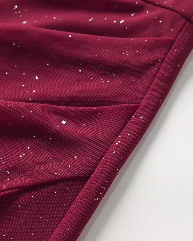 Close-up of a maroon fabric with small white dots on a light gray background