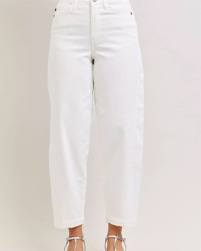 White jeans worn by a person on a plain background