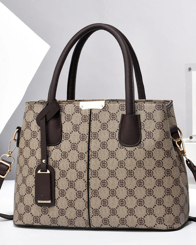 Patterned handbag with brown handles and strap on a white background