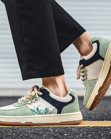 Person wearing green and navy sneakers with a brown sole on a blurred background