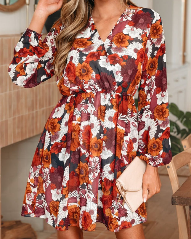 Woman wearing a floral dress with autumn colors in an indoor setting.