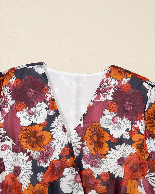Close-up of a floral-patterned garment with vibrant colors on a beige background