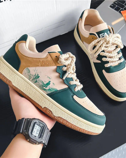 Pair of green and beige sneakers with floral design on a dark surface.