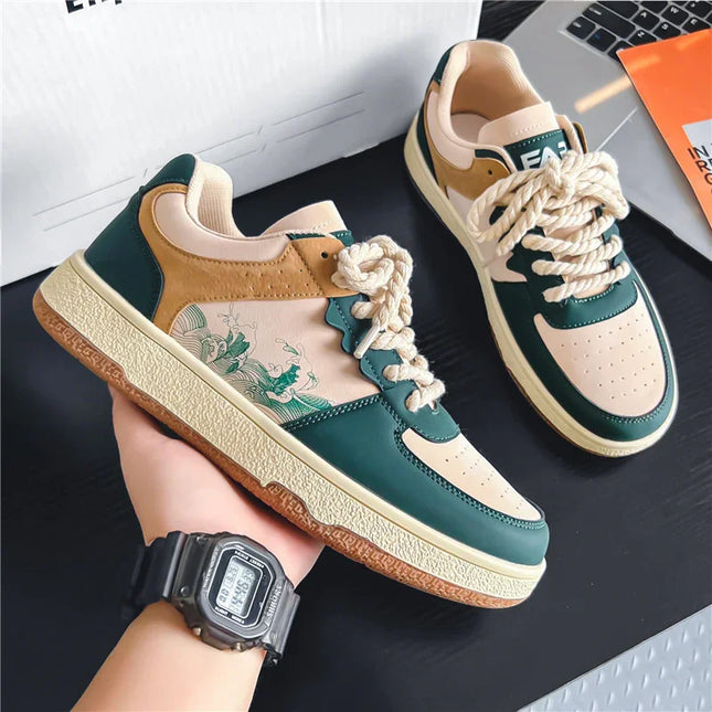 Pair of green and beige sneakers with floral design on a dark surface.