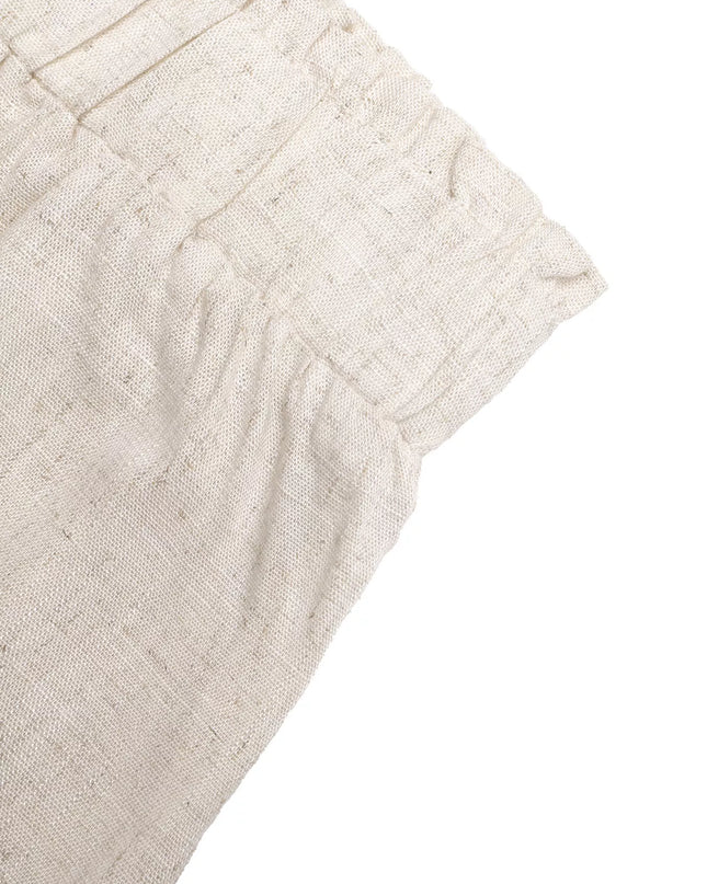 Close-up of beige fabric with a textured pattern on a white background